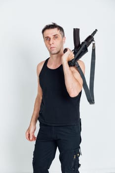 man with a gun standing on a white background