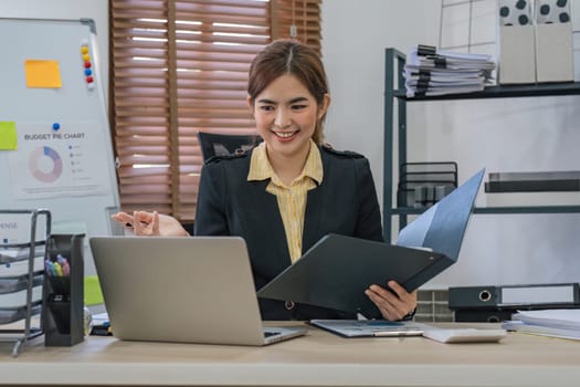 Business woman using calculator for do math finance on wooden desk in office and business working background, tax, accounting, statistics and analytic research concept..