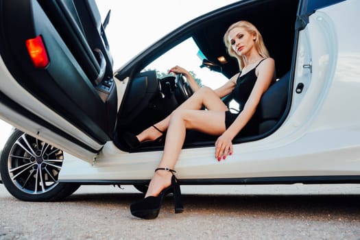 female driver behind the wheel of car gets out of transport