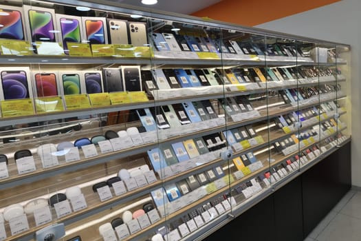 Moscow, Russia - Nov 11. 2023. Cell phones and wireless headphones in DNS network store selling household appliances in the Zelenograd