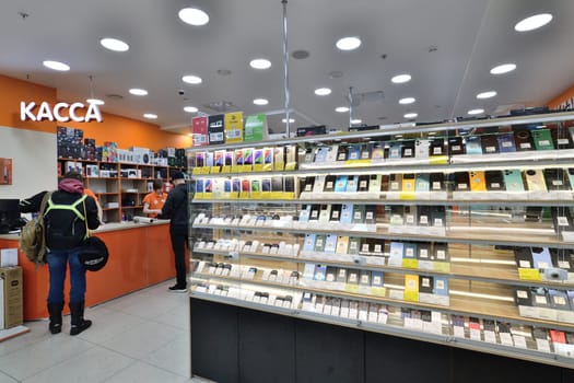 Moscow, Russia - Nov 11. 2023. Cell phones and wireless headphones in DNS network store selling household appliances in the Zelenograd