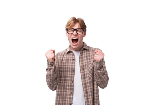 young friendly caucasian red-haired guy in a shirt over a t-shirt.