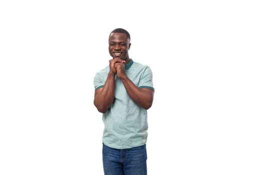 young charismatic american guy dressed in a mint t-shirt on a white background.