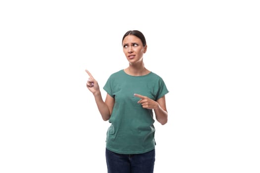 young confident slender woman dressed in green basic t-shirt with print mockup draws attention.