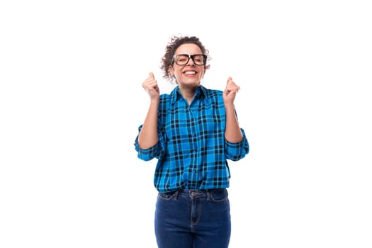 cute young pretty woman with curled hair in a blue shirt is experiencing happiness.
