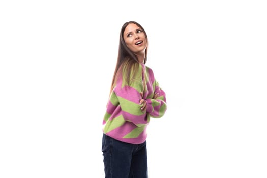 portrait of a well-groomed 35 year old feminine model woman dressed in a pink stylish pullover on a white background with copy space.