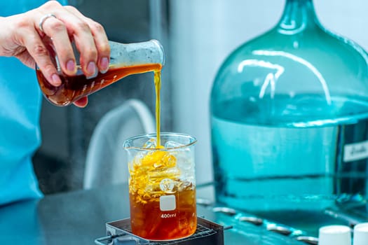 The Cool Mixologist: Bartender's Handcrafting Icy Drinks in Lab Beaker Glass