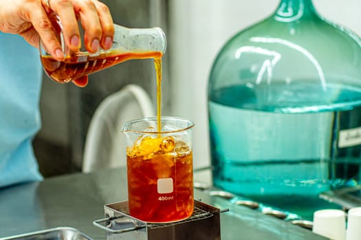 Bartender's Frozen Alchemy: Crafting Ice Beverages in Lab Beaker Glass
