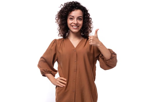 young pretty businesswoman dressed in a brown blouse on a white background with copy space.
