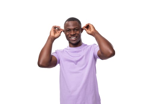 young authentic american guy dressed in a light lilac t-shirt on a white background.