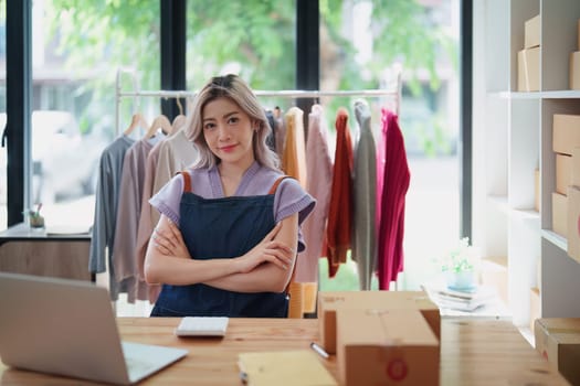 Portrait Of Asian Female Owner Of Fashion Store Clothing Store successful happy smile at small business, sme or ecommerce concepts.