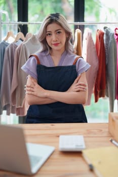 Portrait Of Asian Female Owner Of Fashion Store Clothing Store successful happy smile at small business, sme or ecommerce concepts.