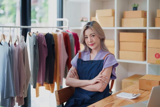 Portrait Of Asian Female Owner Of Fashion Store Clothing Store successful happy smile at small business, sme or ecommerce concepts.