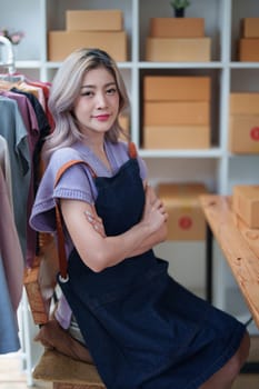 Portrait Of Asian Female Owner Of Fashion Store Clothing Store successful happy smile at small business, sme or ecommerce concepts.