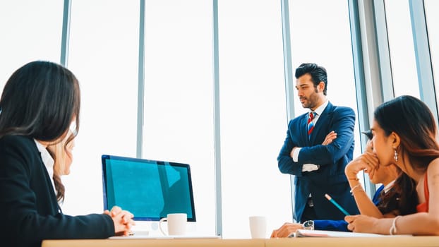 Business people in the conference room with green screen chroma key TV or computer on the office table. Diverse group of businessman and businesswoman in meeting on video conference call . Jivy