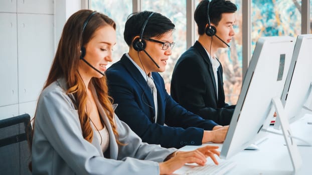 Business people wearing headset working in office to support remote customer or colleague. Call center, telemarketing, customer support agent provide service on telephone video conference call. Jivy