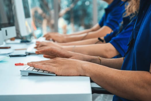 Close up shot of business people hand typing and working on desktop computer on the office desk. Business communication and workplace concept. Jivy