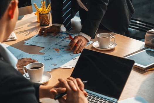 Smart businessman and businesswoman talking discussion in group meeting at office table in a modern office interior. Business collaboration strategic planning and brainstorming of coworkers. Jivy