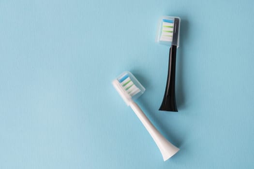 Modern electric toothbrush on a blue background. Hygiene concept for daily oral care