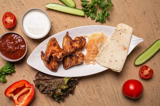 shish kebab of chicken wings on a white plate.