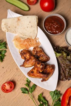 top view of chicken wings kebab. barbecue on the table in a cafe.