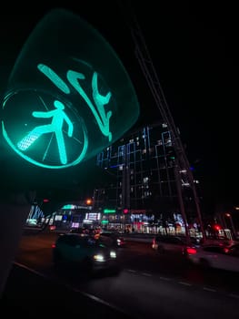 green traffic light at night. street photography at a wide angle.