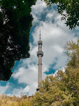 Almaty TV Tower view through the trees in summer.