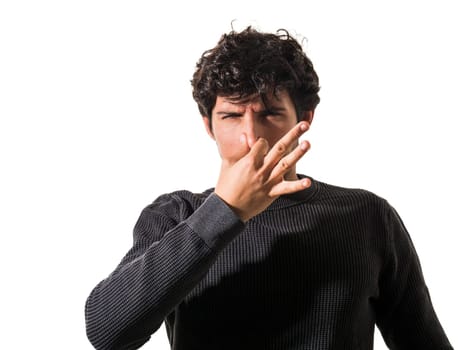 A man making a funny face with his finger, closing his nose because of foul smell or bad odour