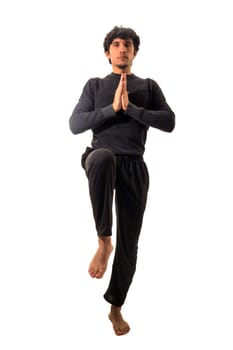 A man is doing a yoga pose on a white background