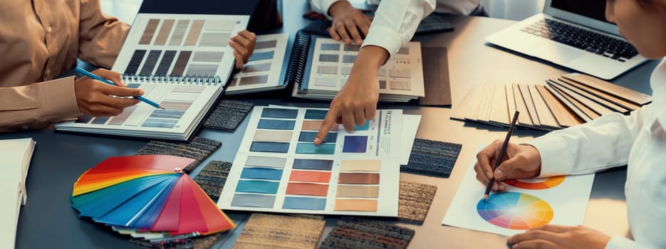 Group of professional interior designer and architect working together, planning and choosing color samples in office for house design or renovation. Insight