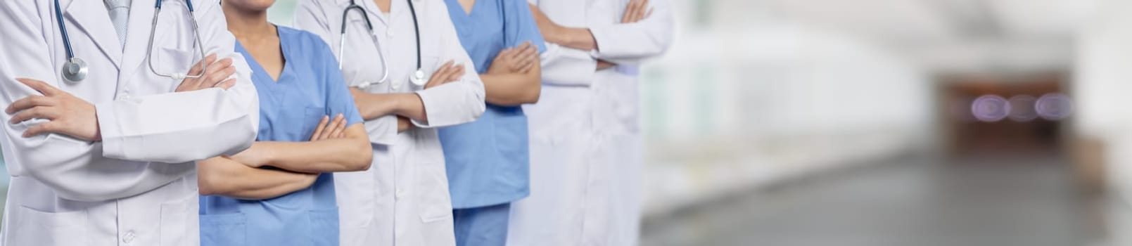 Confident medical staff team with doctor nurse and healthcare specialist professions people in blurry hospital corridor background. Medical and healthcare community in panoramic banner. Neoteric