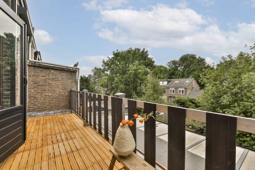 an outside area with wooden decking and trees in the background, on a sunny day looking out to the backyard
