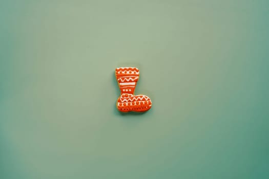 Colorful cookie boot lies in the middle on a green background. High quality photo