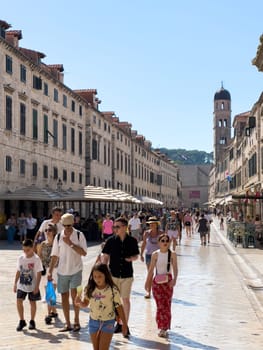 Tourists walk along the cobbled square of the old town. High quality photo