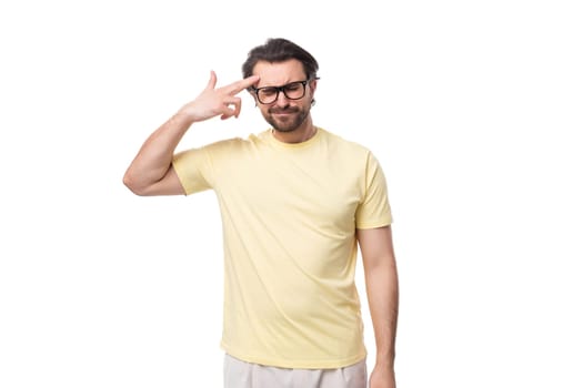 portrait of a casual caucasian guy with a beard in glasses dressed in a light t-shirt on a white background.