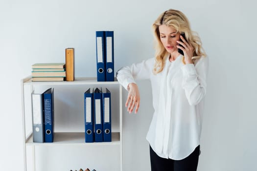 Blonde woman is having conversations about work in the office