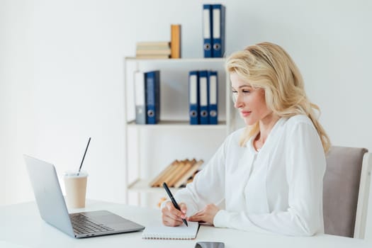 Business woman secretary working with laptop computer in office