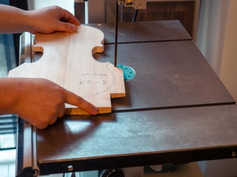 violin maker sawing a classical italian violin top plate