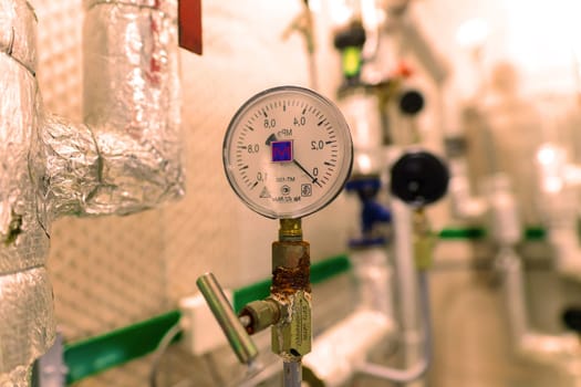 Pressure sensor in an industrial boiler room. Barometer in a heating system. Close-up.