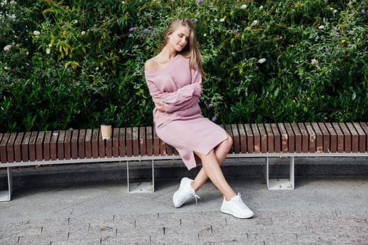 a woman sitting on a park bench outside rest walk