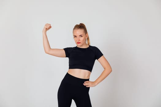 a woman in black tracksuit exercise sport in the gym warm-up exercises