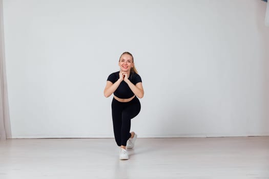 a woman in black tracksuit exercise sport in the gym warm-up exercises