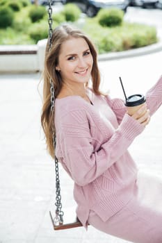 woman with a glass of coffee drink cocoa tea on the carousel