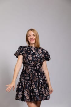 beautiful blonde in a dress on white background in the room