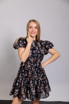 beautiful blonde in a dress on white background in the room