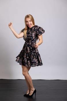 a beautiful blonde dancing on a white background