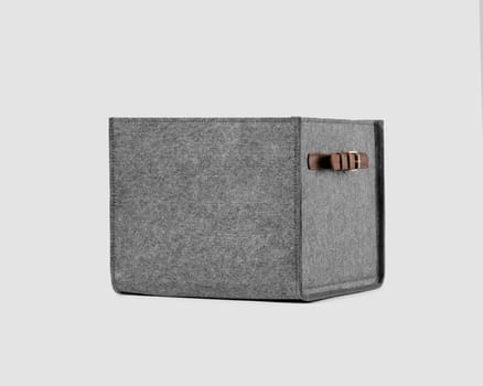 Compact practical box of gray felt with brown faux leather handles for convenient storage of clothes or books. Handmade interior items