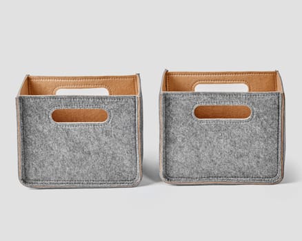 Two handcrafted boxes in gray felt with beige lining and slotted handles for comfortable sorting and storage of things. Stylish accessories to organize home and office space