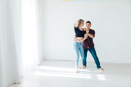 a man and a woman dance bachata latin casombu salta in the studio hall