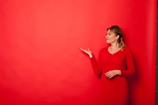 a blonde in red shows direction on red background